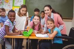 Teacher in a classroom with a group of early primary students