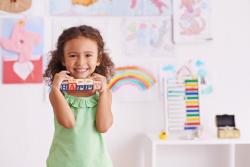 Preschooler holding blocks 