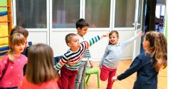 Young children in a classroom exercising