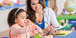 a teacher observing a child playing with blocks