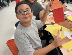 A student showing his artwork