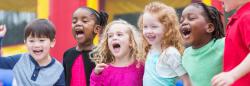 Group of five diverse children playing outdoors