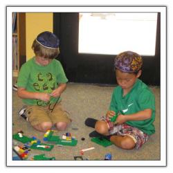 Two boys playing with blocks on floor