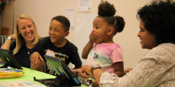 Two teachers laughing with two students