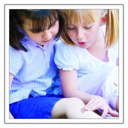 two little girls, one of whom has a Band-Aid on her leg