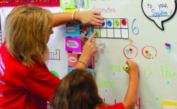 A teacher helps a child develop math concepts