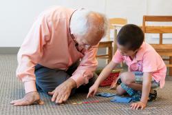 Teacher playing math game with child