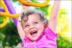 Child playing on outdoor rings.