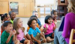 Preschool class sitting in circle for story time 