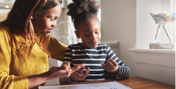 With support from her teacher, a young child develops math concepts.