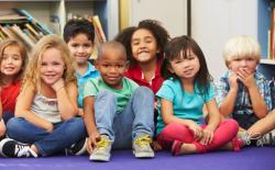 A diverse group of young children looking forward to a read aloud