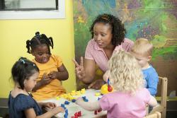 Teacher and children counting plastic bears.