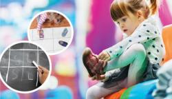 A young child participates in a math activity charting children's types of shoes.