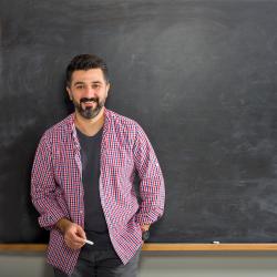 Man in front of chalk board