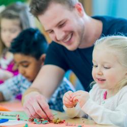 A teacher engages with a child