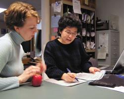 Two women looking at paperwork together