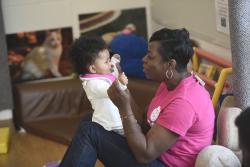 Black early childhood educator with young child