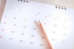 A pencil sits on a calendar.
