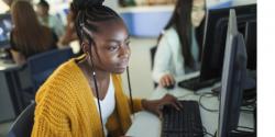 Higher Education student at a computer in a classroom