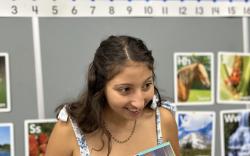 Isabel Calderon reading a book to students