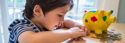 Young child counting with coins