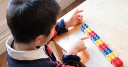 Boy counting his lego blocks