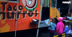 Preschoolers standing at taco truck