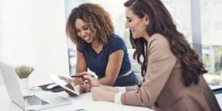 Two women looking at a laptop computer