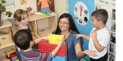 Margarita Barragan in a classroom with three preschoolers