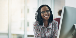 A young professional sitting in front of a computer.