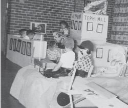 an old photo of children playing in a craft airplane