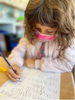 A young child drawing