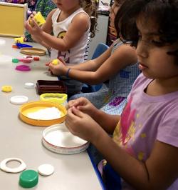 Children in a classroom playing with playdough