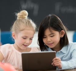 Two girls looking at a screen