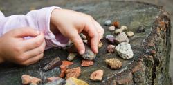 Child playing with rocks