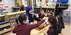 Teacher and students setting up project in class