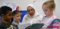 Teacher reading a book to sutdents