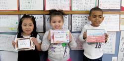 Three students holding their math mini-books