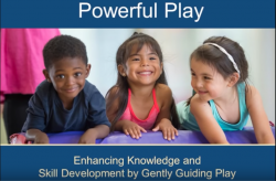 Two preschool girls and one boy in a classroom laughing