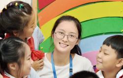 Teacher in a classroom with 3 young children