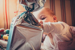 Baby playing with a wrapped gift