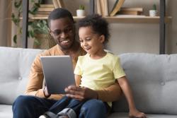 a parent with a child on  a tablet