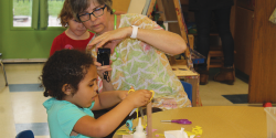 A teacher documenting a child's explorations.