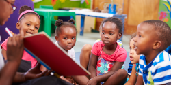 a group of children being read to