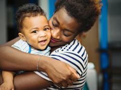 a parent hugging a toddler