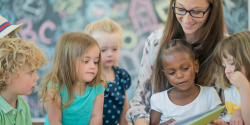 children reading with a teacher