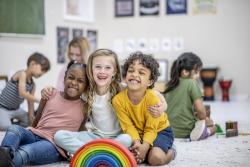 Children posing for a picture in a classroom