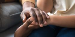 Several people hold hands