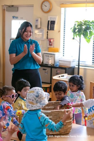 A teacher encouraging students in a classroom activity