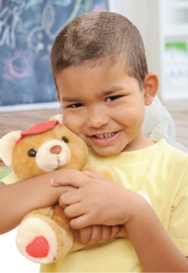 Boy hugging stuffed animal